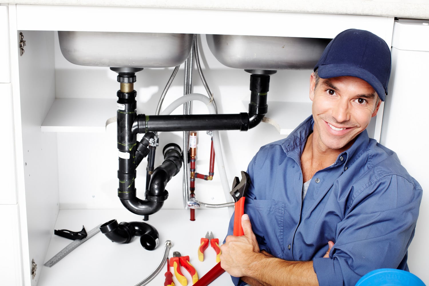Young Smiling Plumber Fixing A Sink